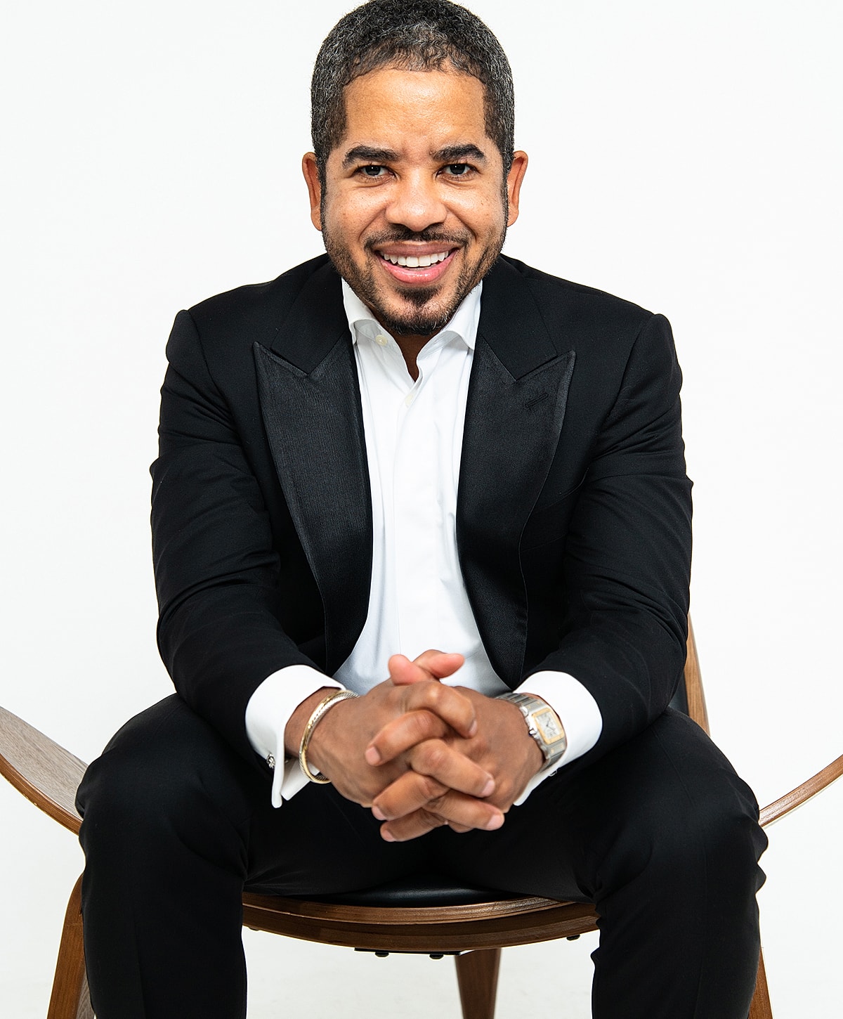 Doctor in white coat smiling confidently.