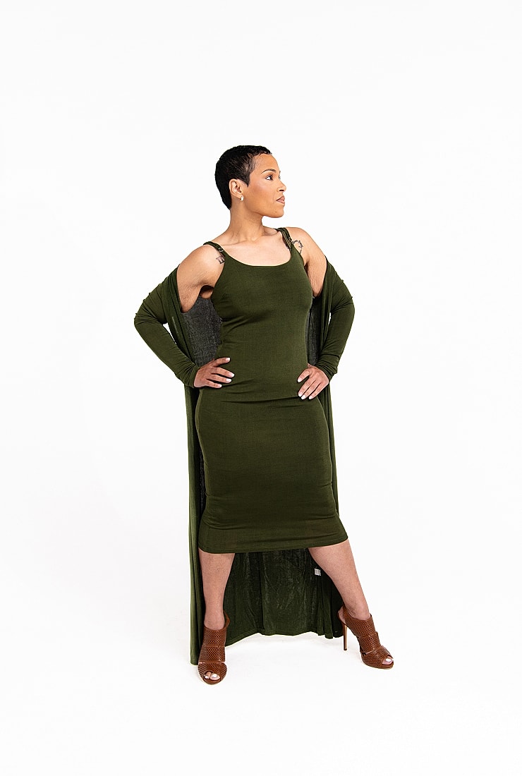 Woman in green dress with open cardigan.
