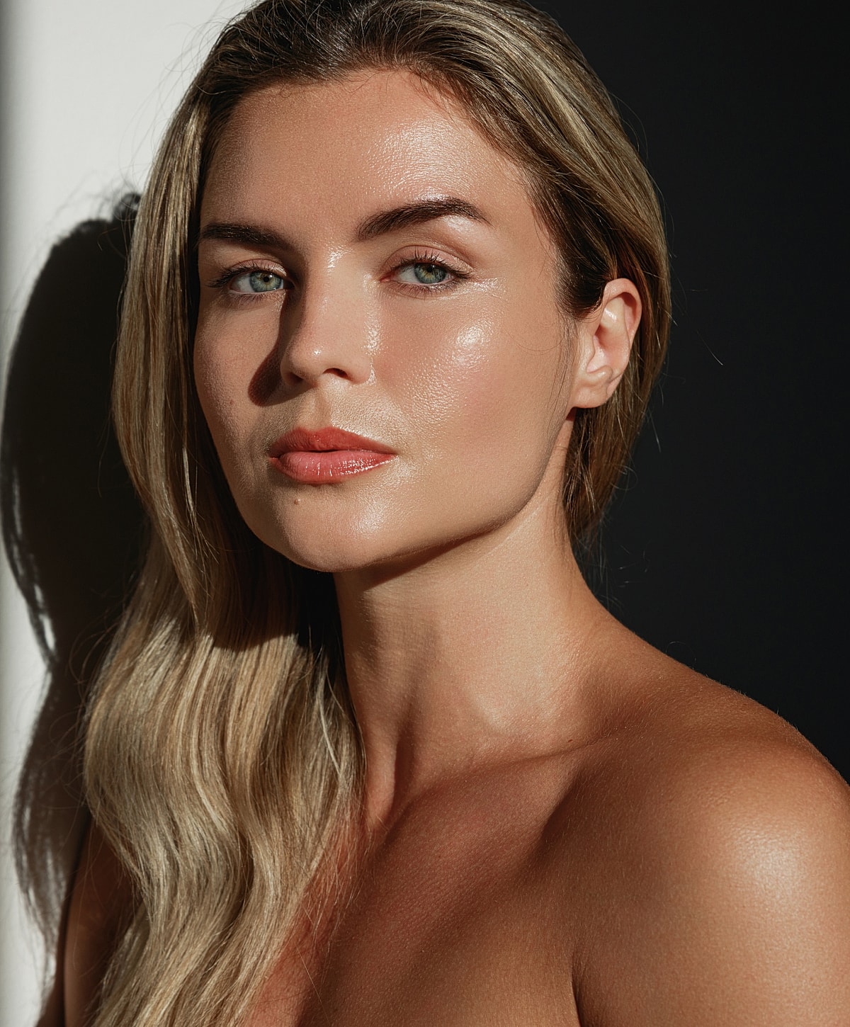 Woman with luminous skin and flowing hair.