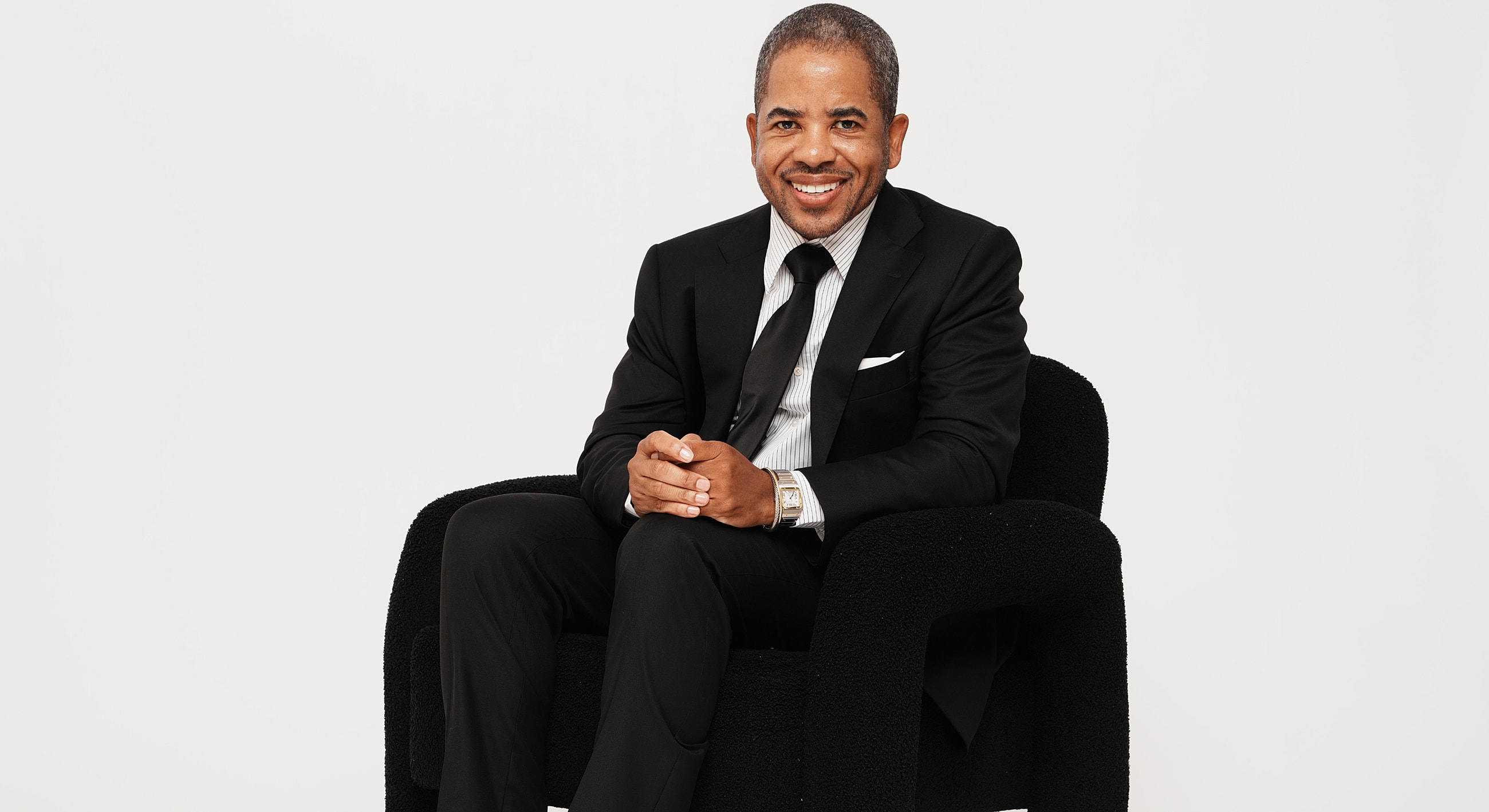 Smiling woman lying in grass outdoors.